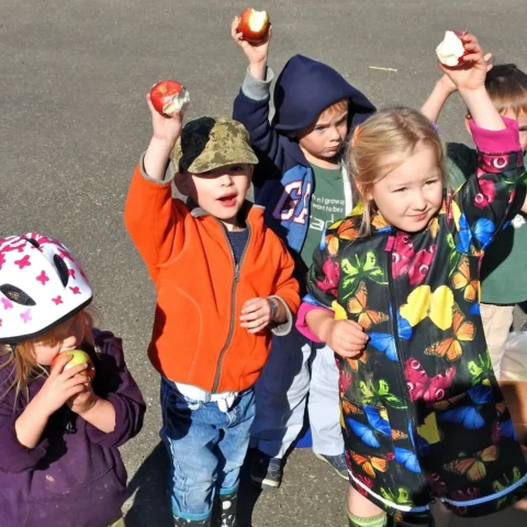 Children Holding Their Apples Up in the Air