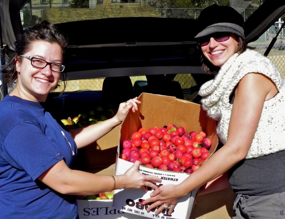 OFRE Annual General Meeting (AGM) 1 Fruit Picker Volunteers With a Box of Apples