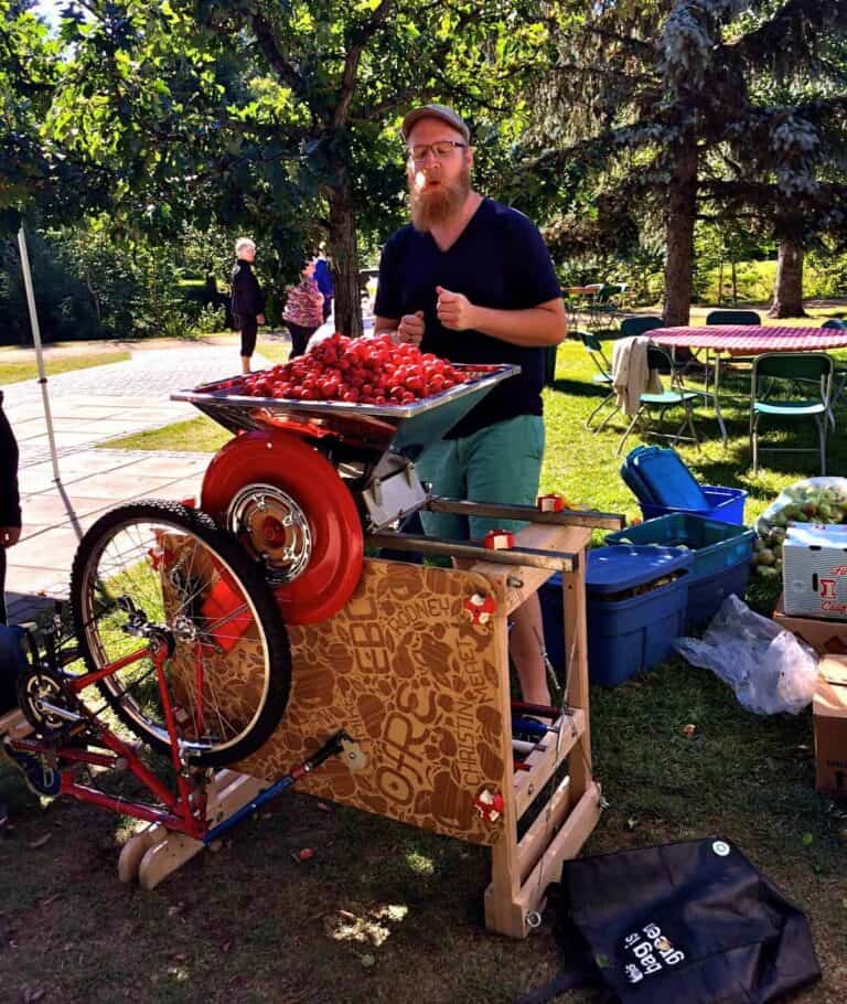 Operation Fruit Rescue Edmonton bicycle powered apple crusher with a load of apples