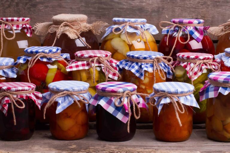 Preserved fruit in canning jars with decorated lids